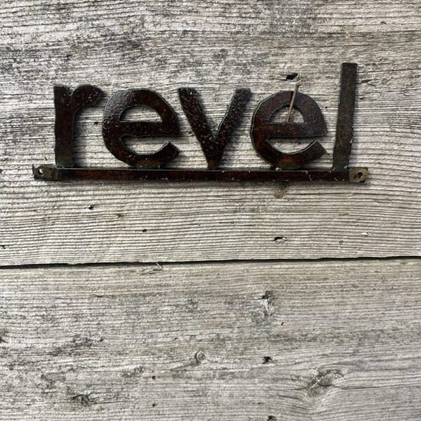 Revel Word Sign